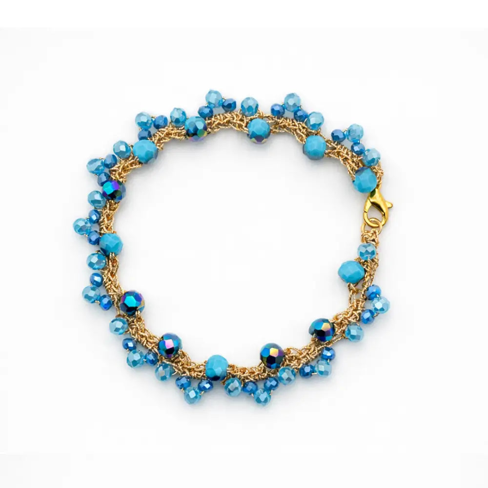 Bracciale handmade Marea in cristalli sfaccettati azzurro oceano con catena dorata